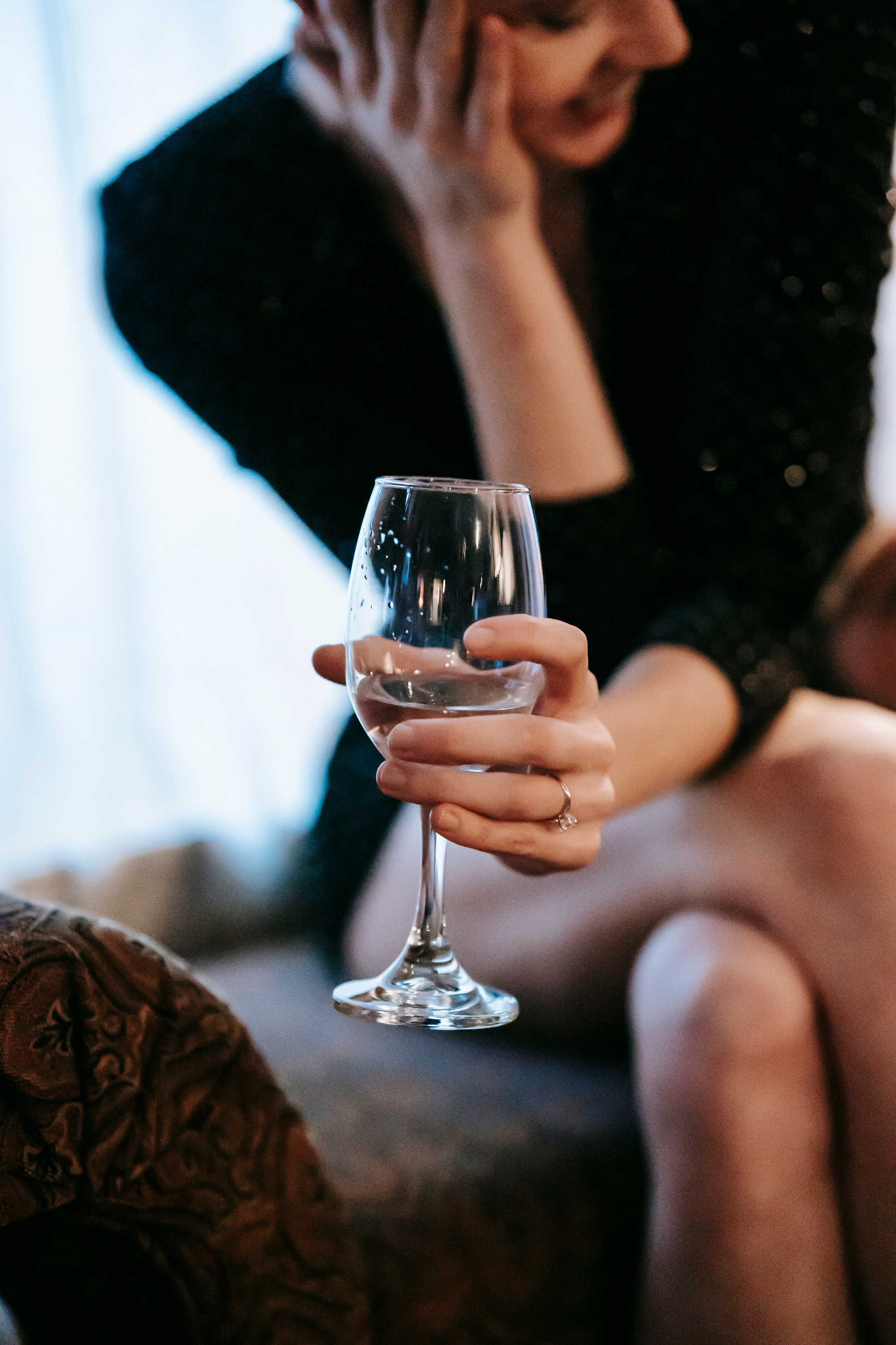 Smiling elegant woman sitting with wineglass